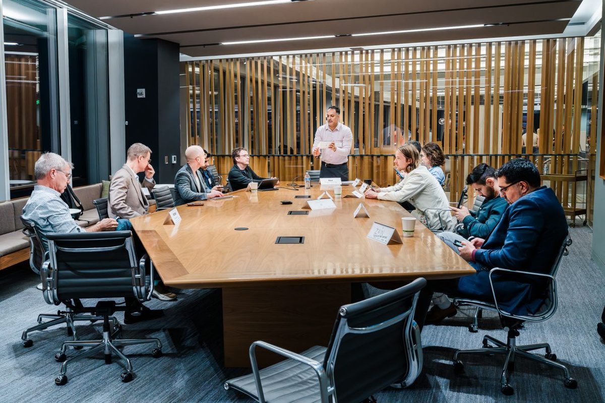 Founders pitching to investors around a boardroom table