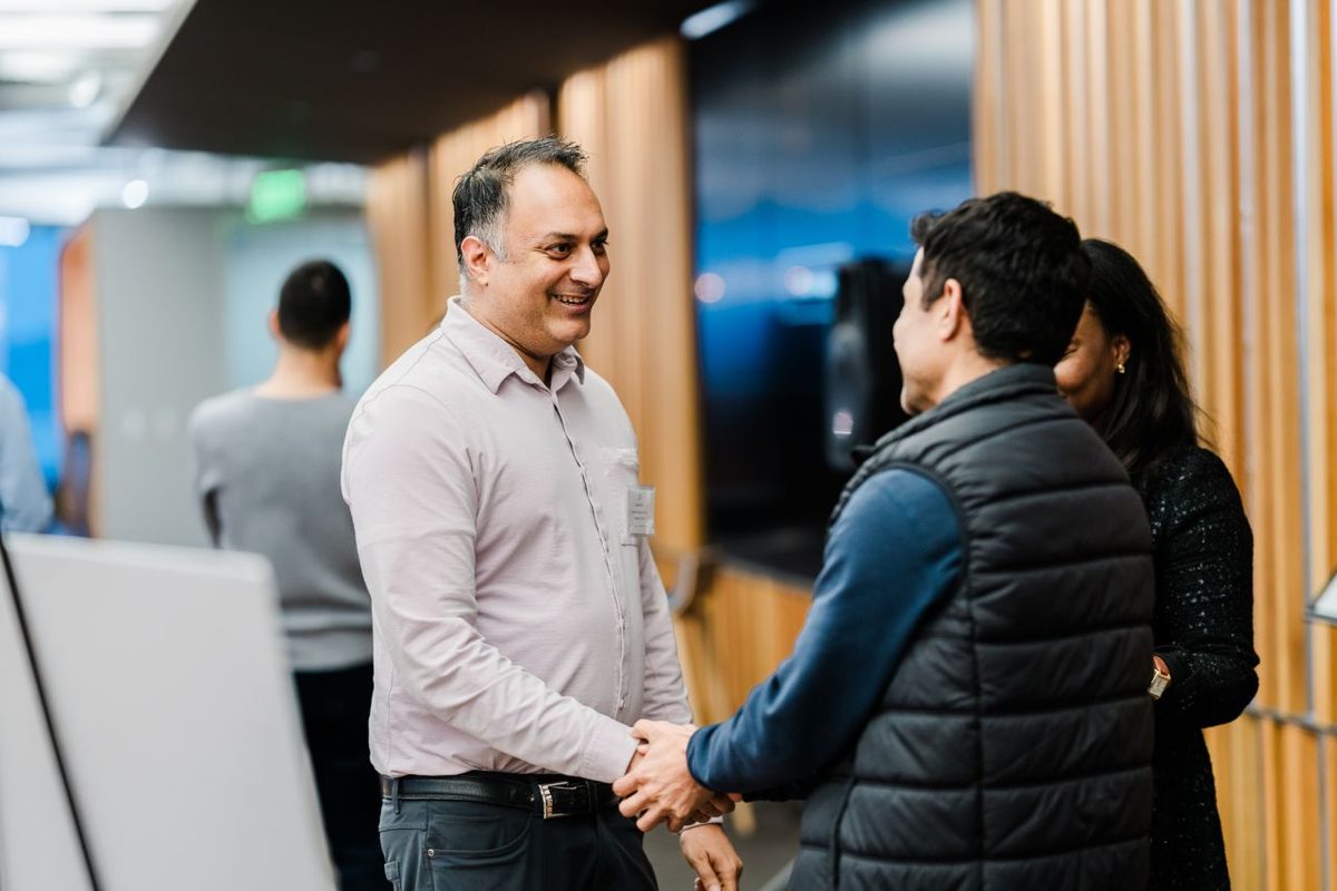 An Alchemist team member greeting a founder